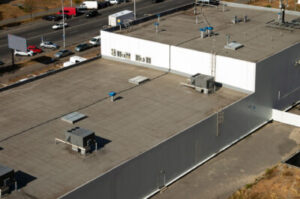 An aerial view of the roof of a commercial building with an HVAC system