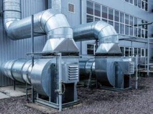 Exterior components of commercial refrigeration units outside of a warehouse